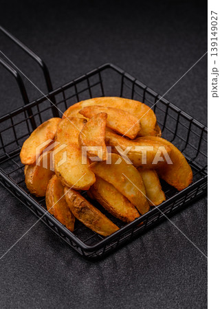 Potato wedges baked with garlic, herbs, and spices for lunch. Potato wedges Potato wedges baked with garlic, herbs, and spices for lunch. Potato wedges 139149027