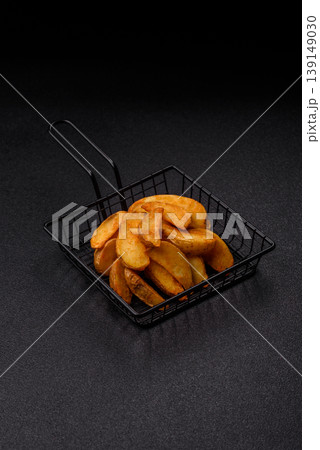 Potato wedges baked with garlic, herbs, and spices for lunch. Potato wedges Potato wedges baked with garlic, herbs, and spices for lunch. Potato wedges 139149030