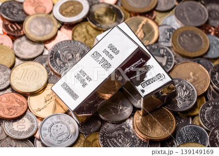 A silver bar, white metal against a backdrop of money, as a concept for the sales. A silver bar A silver bar, white metal against a backdrop of money, as a concept for the sales. A silver bar 139149169