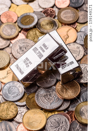 A silver bar, white metal against a backdrop of money, as a concept for the sales. A silver bar 139149171