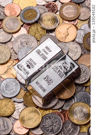 A silver bar, white metal against a backdrop of money, as a concept for the sales. A silver bar A silver bar, white metal against a backdrop of money, as a concept for the sales. A silver bar 139149182