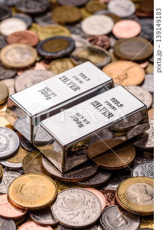 A silver bar, white metal against a backdrop of money, as a concept for the sales. A silver bar 139149183