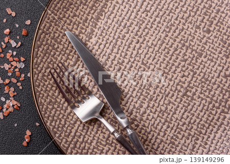 An empty ceramic round plate, kitchen utensils for a dinner table. An empty plate An empty ceramic round plate, kitchen utensils for a dinner table. An empty plate 139149296