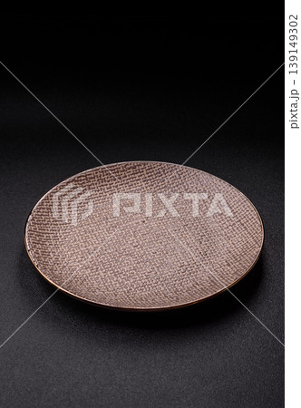 An empty ceramic round plate, kitchen utensils for a dinner table. An empty plate An empty ceramic round plate, kitchen utensils for a dinner table. An empty plate 139149302