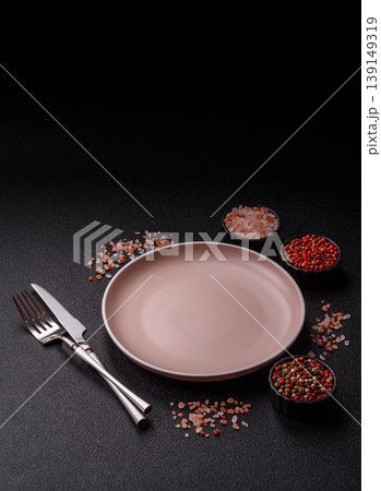 An empty ceramic round plate, kitchen utensils for a dinner table. An empty plate An empty ceramic round plate, kitchen utensils for a dinner table. An empty plate 139149319
