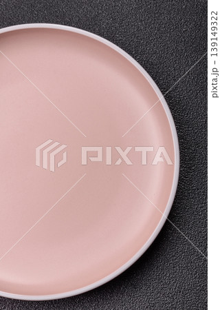 An empty ceramic round plate, kitchen utensils for a dinner table. An empty plate An empty ceramic round plate, kitchen utensils for a dinner table. An empty plate 139149322
