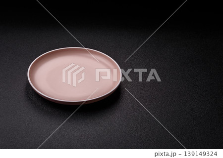 An empty ceramic round plate, kitchen utensils for a dinner table. An empty plate 139149324