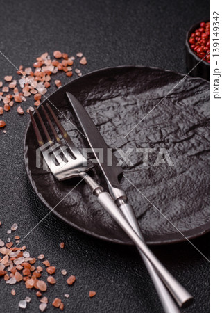 An empty ceramic round plate, kitchen utensils for a dinner table. An empty plate An empty ceramic round plate, kitchen utensils for a dinner table. An empty plate 139149342