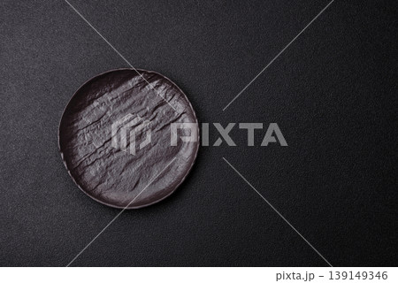 An empty ceramic round plate, kitchen utensils for a dinner table. An empty plate An empty ceramic round plate, kitchen utensils for a dinner table. An empty plate 139149346