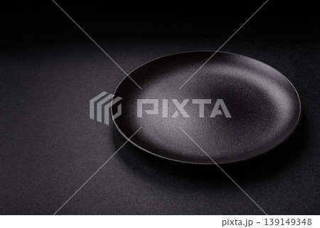 An empty ceramic round plate, kitchen utensils for a dinner table. An empty plate An empty ceramic round plate, kitchen utensils for a dinner table. An empty plate 139149348
