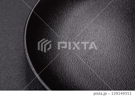 An empty ceramic round plate, kitchen utensils for a dinner table. An empty plate 139149351