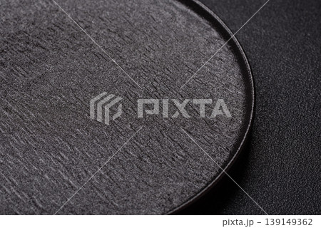An empty ceramic round plate, kitchen utensils for a dinner table. An empty plate An empty ceramic round plate, kitchen utensils for a dinner table. An empty plate 139149362
