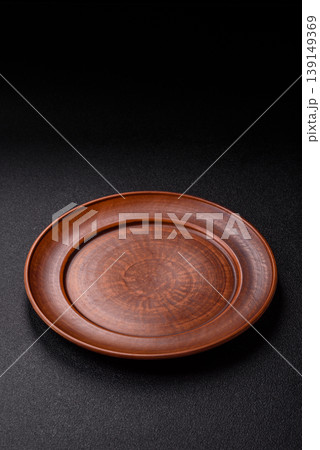 An empty ceramic round plate, kitchen utensils for a dinner table. An empty plate 139149369
