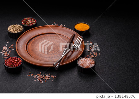 An empty ceramic round plate, kitchen utensils for a dinner table. An empty plate 139149376
