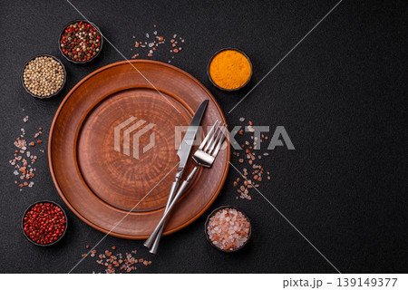 An empty ceramic round plate, kitchen utensils for a dinner table. An empty plate 139149377