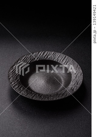 An empty ceramic round plate, kitchen utensils for a dinner table. An empty plate 139149421