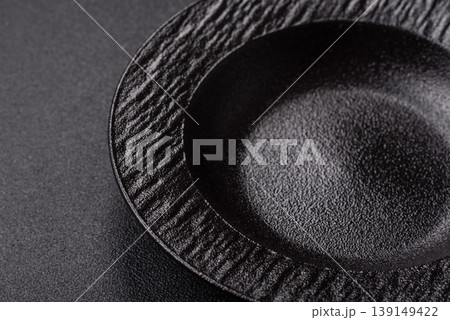 An empty ceramic round plate, kitchen utensils for a dinner table. An empty plate An empty ceramic round plate, kitchen utensils for a dinner table. An empty plate 139149422