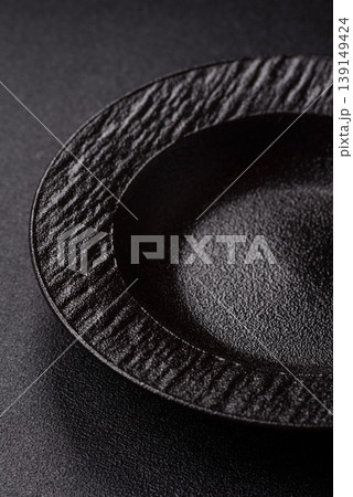 An empty ceramic round plate, kitchen utensils for a dinner table. An empty plate 139149424