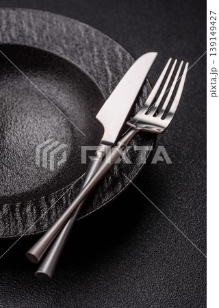 An empty ceramic round plate, kitchen utensils for a dinner table. An empty plate An empty ceramic round plate, kitchen utensils for a dinner table. An empty plate 139149427