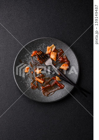 A dirty plate after a meal with leftover pasta and tomato sauce, cleaning. An empty dirty plate A dirty plate after a meal with leftover pasta and tomato sauce, cleaning. An empty dirty plate 139149487
