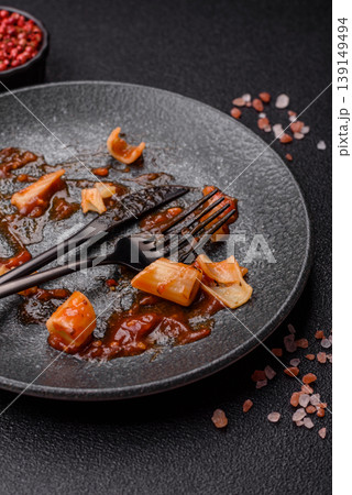 A dirty plate after a meal with leftover pasta and tomato sauce, cleaning. An empty dirty plate A dirty plate after a meal with leftover pasta and tomato sauce, cleaning. An empty dirty plate 139149494