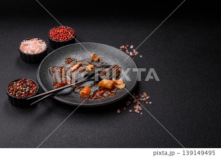 A dirty plate after a meal with leftover pasta and tomato sauce, cleaning. An empty dirty plate A dirty plate after a meal with leftover pasta and tomato sauce, cleaning. An empty dirty plate 139149495