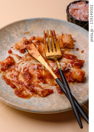 A dirty plate after a meal with leftover pasta and tomato sauce, cleaning. An empty dirty plate A dirty plate after a meal with leftover pasta and tomato sauce, cleaning. An empty dirty plate 139149502
