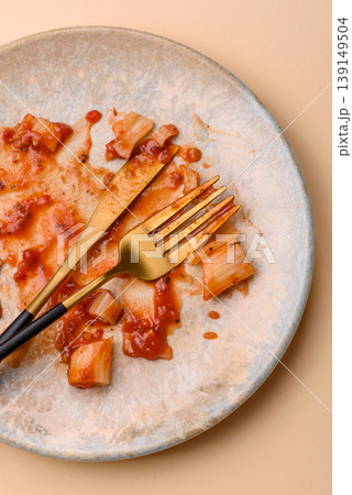 A dirty plate after a meal with leftover pasta and tomato sauce, cleaning. An empty dirty plate A dirty plate after a meal with leftover pasta and tomato sauce, cleaning. An empty dirty plate 139149504