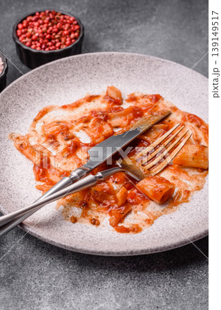 A dirty plate after a meal with leftover pasta and tomato sauce, cleaning. An empty dirty plate A dirty plate after a meal with leftover pasta and tomato sauce, cleaning. An empty dirty plate 139149517