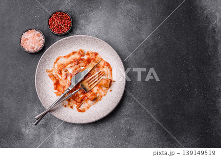 A dirty plate after a meal with leftover pasta and tomato sauce, cleaning. An empty dirty plate A dirty plate after a meal with leftover pasta and tomato sauce, cleaning. An empty dirty plate 139149519
