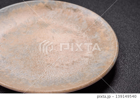 An empty ceramic round plate, kitchen utensils for a dinner table. An empty plate 139149540