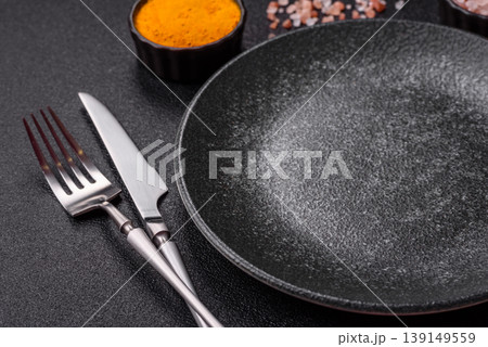 An empty ceramic round plate, kitchen utensils for a dinner table. An empty plate An empty ceramic round plate, kitchen utensils for a dinner table. An empty plate 139149559