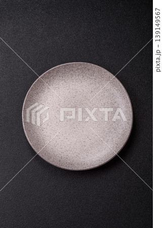 An empty ceramic round plate, kitchen utensils for a dinner table. An empty plate An empty ceramic round plate, kitchen utensils for a dinner table. An empty plate 139149567