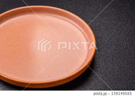 An empty ceramic round plate, kitchen utensils for a dinner table. An empty plate An empty ceramic round plate, kitchen utensils for a dinner table. An empty plate 139149583