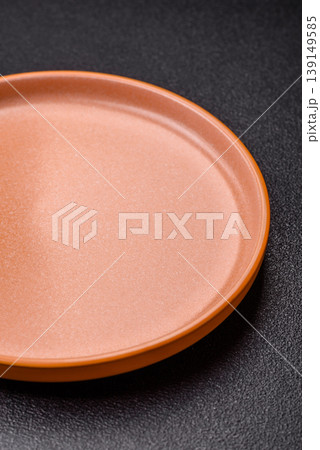 An empty ceramic round plate, kitchen utensils for a dinner table. An empty plate 139149585