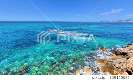 Aerial video shows serene turquoise ocean and rocky formations Aerial video shows serene turquoise ocean and rocky formations 139150025