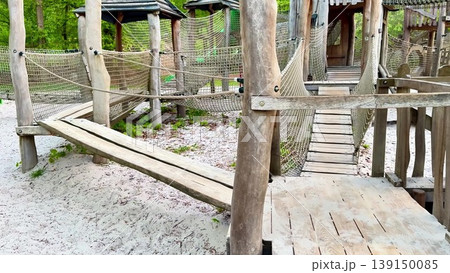 Video features a wooden playground in a lush forest with slides Video features a wooden playground in a lush forest with slides 139150085