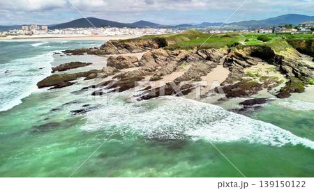 Enjoy a breathtaking scenic coastal view showcasing waves crashing against a rocky shoreline Enjoy a breathtaking scenic coastal view showcasing waves crashing against a rocky shoreline 139150122