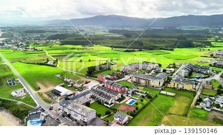 A breathtaking aerial view showcasing the lush green landscapes alongside modern urban development A breathtaking aerial view showcasing the lush green landscapes alongside modern urban development 139150146