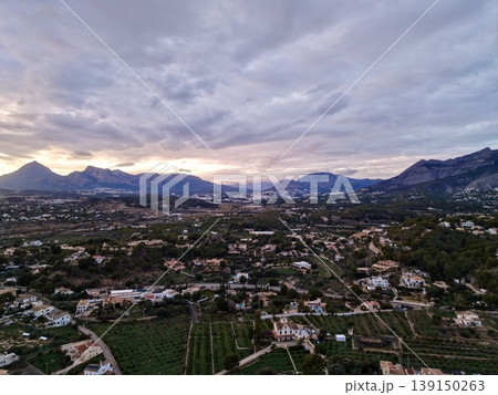 Colors of sunset underscore transition between city outskirts and neighboring agricultural terrains Colors of sunset underscore transition between city outskirts and neighboring agricultural terrains 139150263