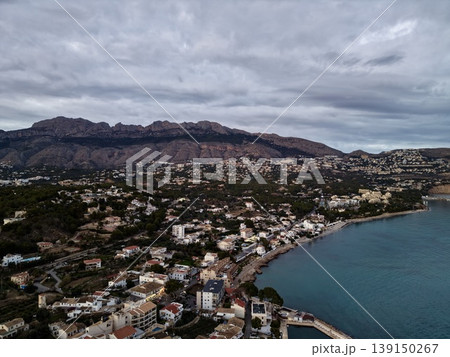 Gloomy seaside landscape, Coastal area under heavy clouds with stormy atmosphere and textured rooftops Gloomy seaside landscape, Coastal area under heavy clouds with stormy atmosphere and textured rooftops 139150267