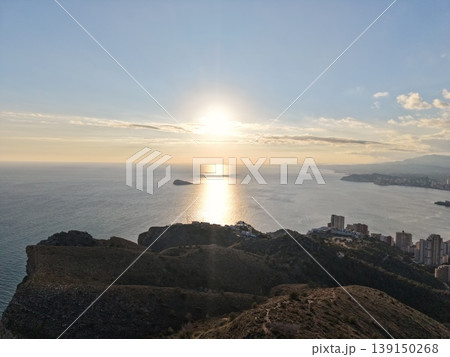 Peaceful coastal landscape view, Golden evening glow reflecting on peaceful sea and distant island 139150268