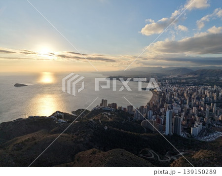 Beautiful twilight illuminating harbor cityscape with shimmering reflections and glowing structures Beautiful twilight illuminating harbor cityscape with shimmering reflections and glowing structures 139150289