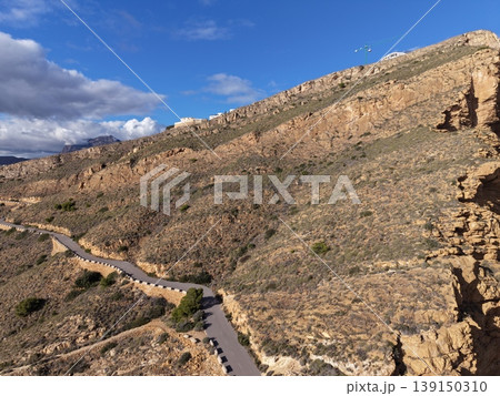 Winding trail beside rough cliffs presenting expansive ocean scenery and encouraging early morning trekking Winding trail beside rough cliffs presenting expansive ocean scenery and encouraging early morning trekking 139150310