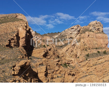Luminous ravine summit emphasizing intricate layers and warm coloration of sedimentary rock surfaces Luminous ravine summit emphasizing intricate layers and warm coloration of sedimentary rock surfaces 139150313