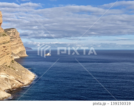 Solitary vessel horizon, Peaceful expansive ocean view showcasing single ship against layered cloud backdrop 139150319