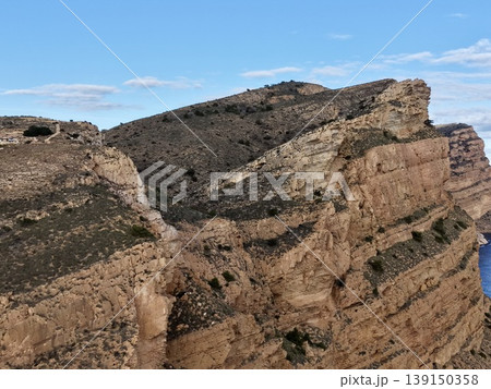 Hidden cove surrounded by rocky formations and gentle waters under soft lighting conditions 139150358