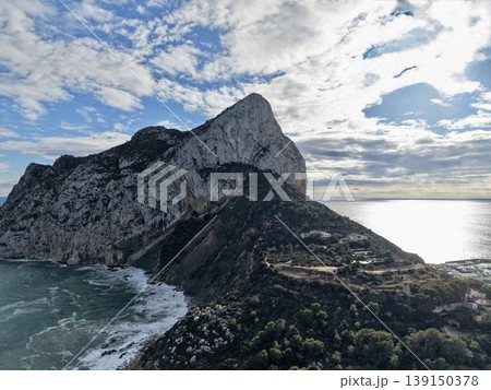 Spectacular shoreline panorama featuring vibrant clouds reflecting on peaceful ocean waters Spectacular shoreline panorama featuring vibrant clouds reflecting on peaceful ocean waters 139150378