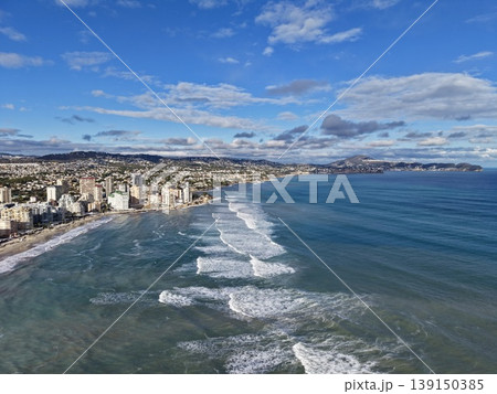 Intense coastal storm with urban backdrop, Majestic shoreline battle between waves and city skyline Intense coastal storm with urban backdrop, Majestic shoreline battle between waves and city skyline 139150385