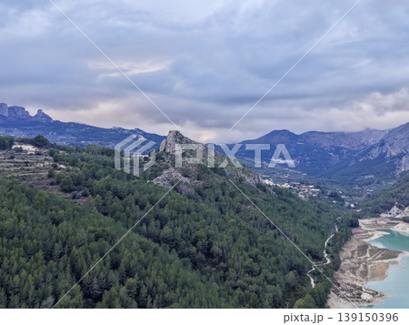 Vast forestridge panoramic vista, Majestic rocky outcrop with scenic valley beneath and distant peaks Vast forestridge panoramic vista, Majestic rocky outcrop with scenic valley beneath and distant peaks 139150396